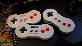 Different variations of the NES Dogbone controller "Nintendo, Retro Bit, and Tomee"