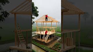Thai-style wooden stilt house  with rice fields, garden beds, and mountain fog.