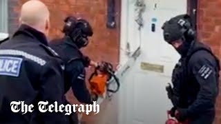 Police use chainsaw to cut through bemused grandfather's front door in raid
