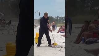 Janitor Mopping The Beach