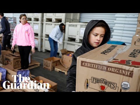 Cleveland residents line up at a food bank during the coronavirus pandemic - Cleveland residents line up at a food bank during the coronavirus pandemic