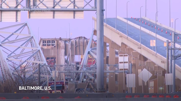 Sunrise shows damage to Baltimore bridge after being rammed by container ship