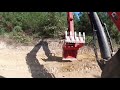 Mini excavator working on a logging road