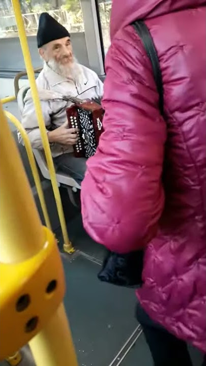 Old russian man playing accordeon