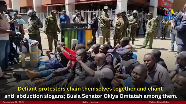 Protesters chain themselves together and chant anti-abduction slogans; Okiya Omtatah among them