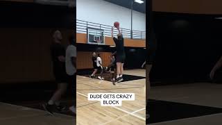 Basketball player sizes up opponent, step back, then defender break the backboard with a block!