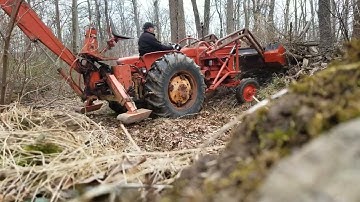 D17 pushing brush on pile with trip loader.