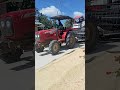 A truck carrying a rice harvester  shorts truck