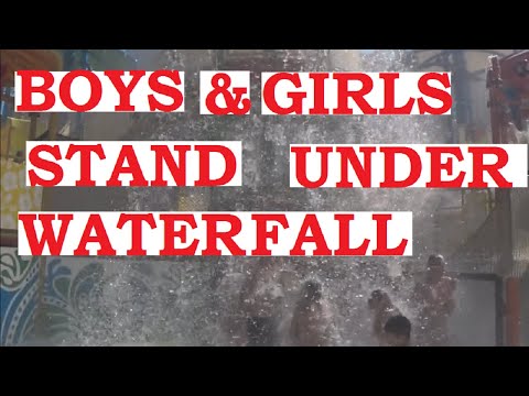 Boys and girls stand under a waterfall #Shorts