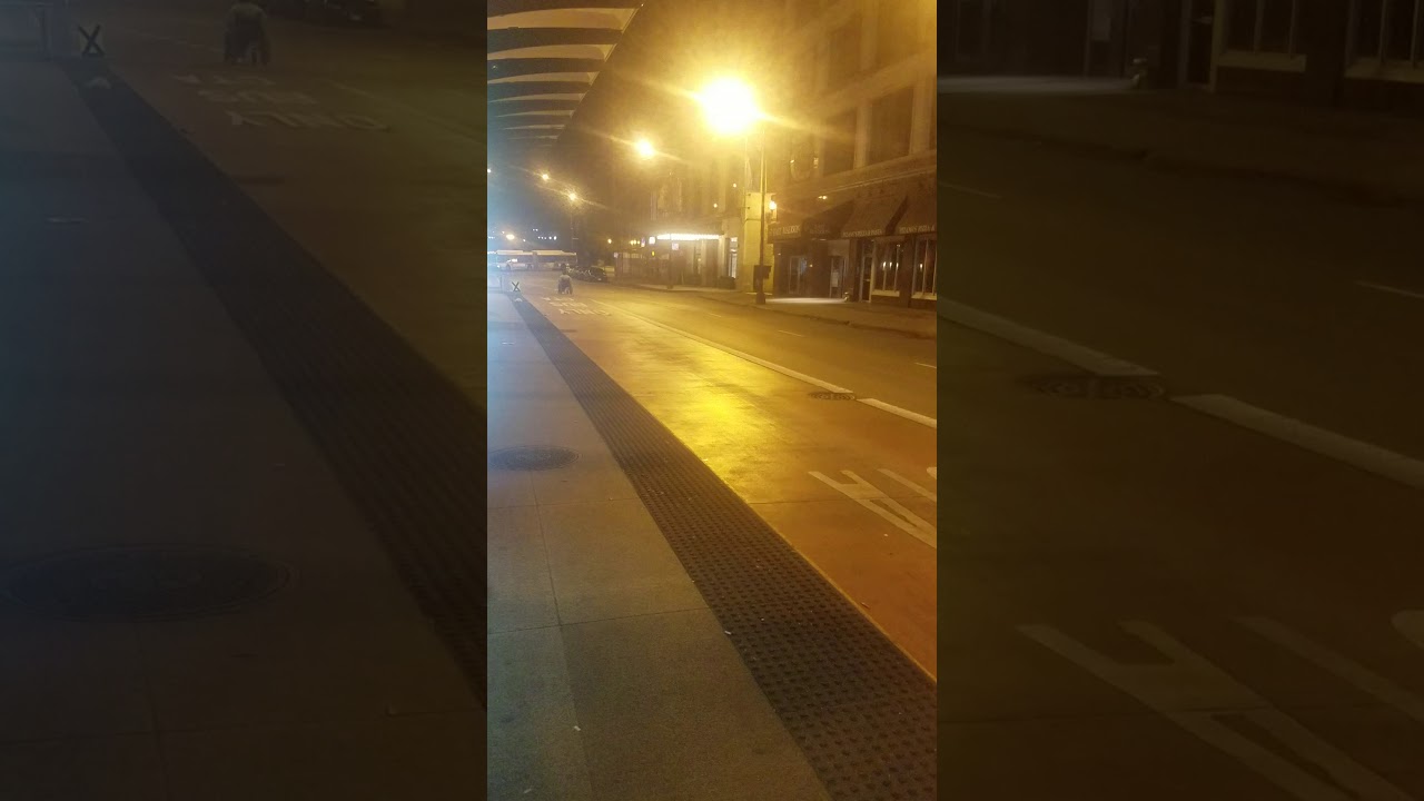 Man in wheelchair  rolling down street