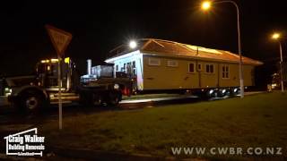 House split in two then shifted on trucks