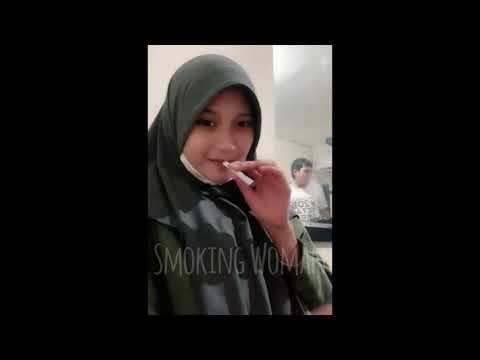 This woman in hijab casually smokes at work