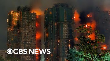 Videos show fire engulfing Hong Kong housing complex