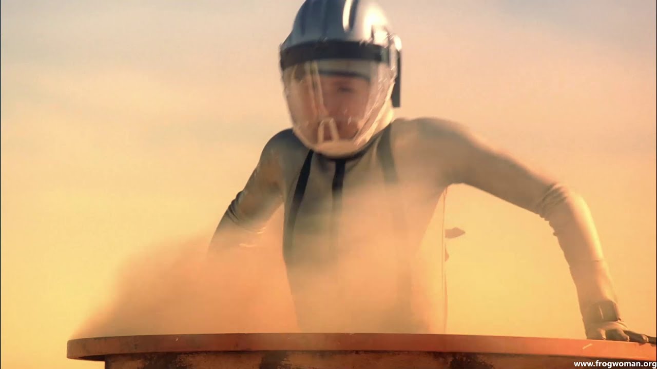 Female agent in wetsuit and hazmat gear infiltrates a facility