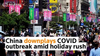 China plays down COVID outbreak amid holiday rush