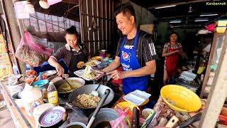 Husband and wife cooking Lao food, restaurant by the street