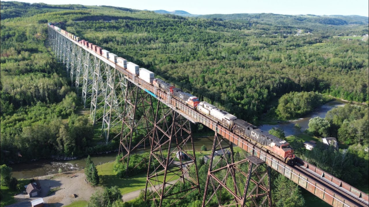 Awesome Aerial 4K Views! Long Stack Train CN 121 Crossing Salmon River Trestle - New Denmark, NB