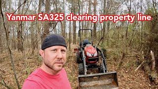 Yanmar SA325 clearing property line for a fence.