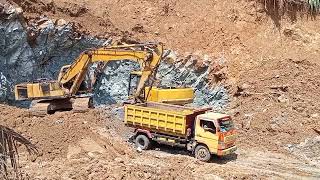 Rock loading dump truck with two komatsu excavators