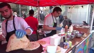 Buying a Pakora Naan Bread Wrap: Indian / Pakistan Street Food at the Alchemy Festival 2016, London.
