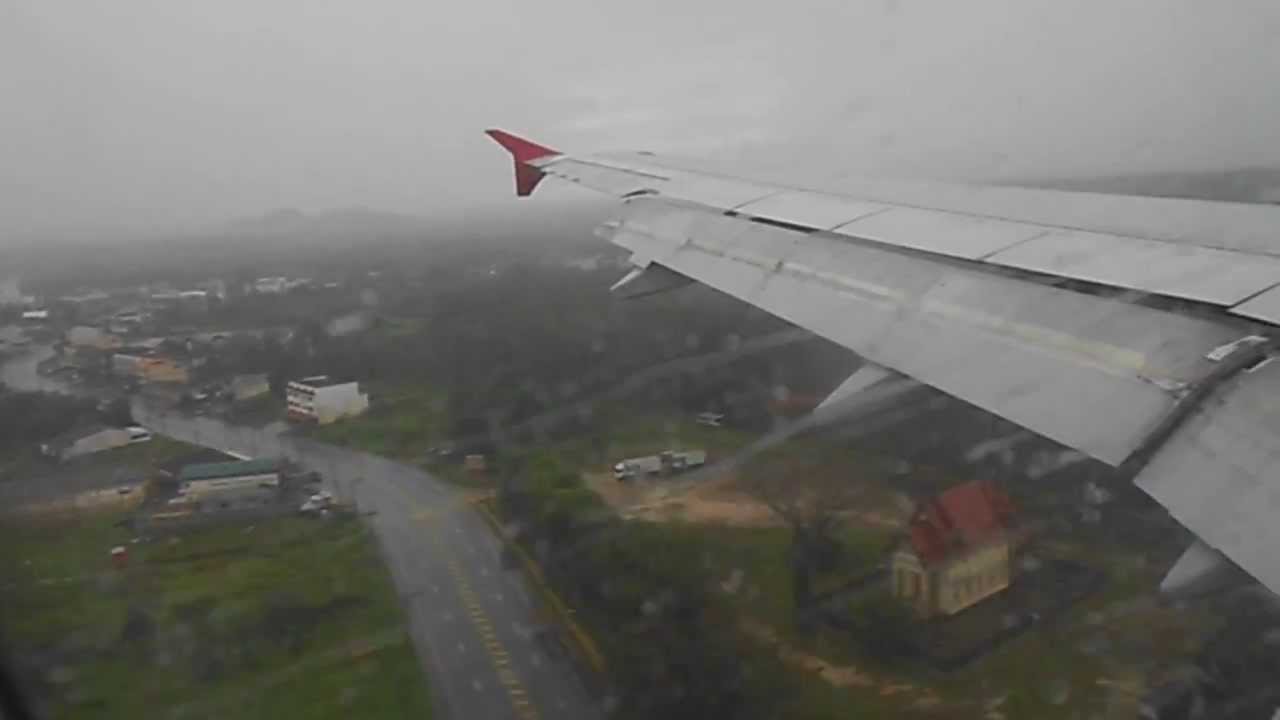 Landing at Krabi Airport in the rain, Part 1. Air Asia flight Airbus A320-200. Krabi Thailand