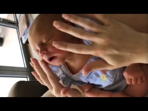 Newborn baby enjoys relaxing face massage