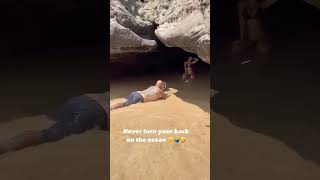 Wave slides hime to her to pass the phone #viral #funny #fail #beach #shorts #beachlife #fun #meme
