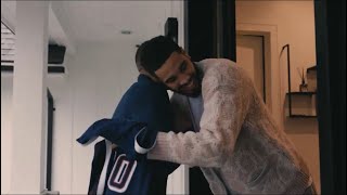 Jrue Holiday and Jayson Tatum receive their jersey from Grant Hill for the Team USA Olympic team