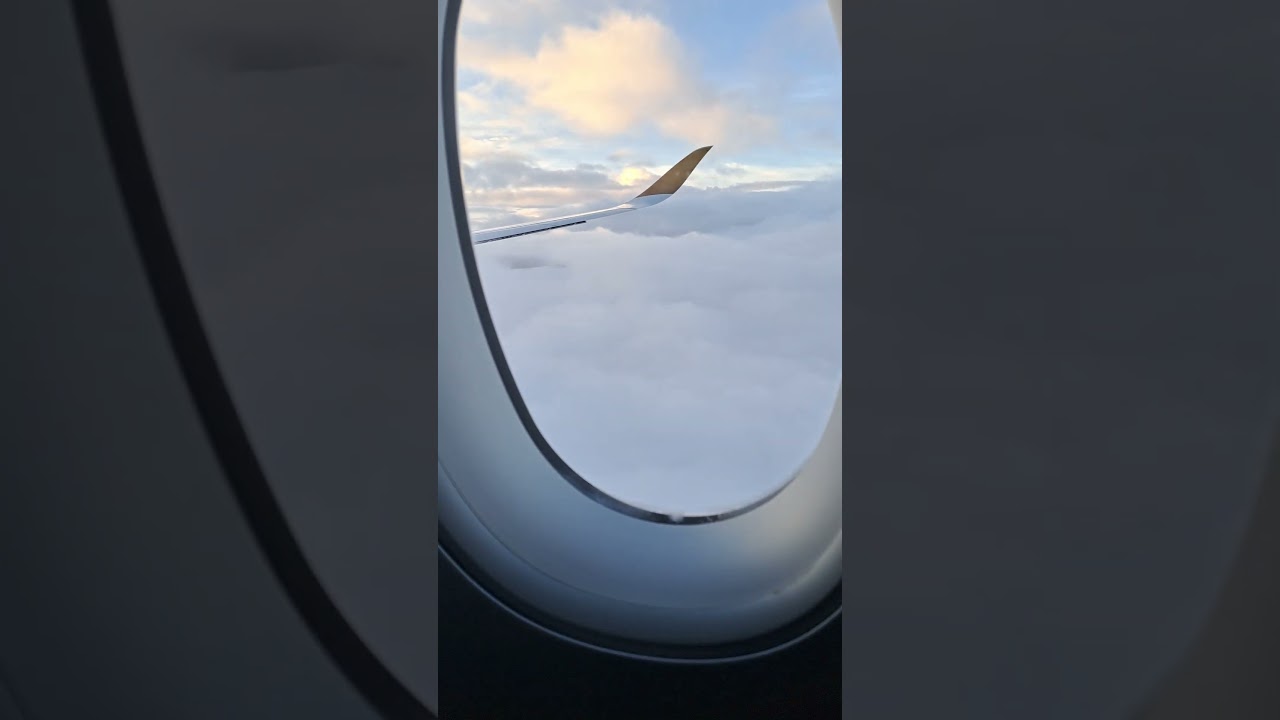 Plane Window View Above Clouds 