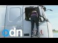 Calais migrant crisis: Moment man climbs into lorry cabin