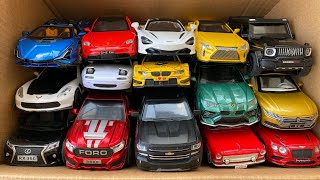 Box full of model Cars, McLaren, LC500, Brabus, Porsche, Crosshairs, Urus, Ford, Mazda.