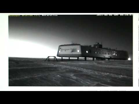 Two people at Neumayer Station in Antarctica launching a Balloon and a weird Moon.