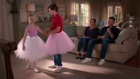 A teenage boy and his little sister in ballet tutus dancing ballet to their parents