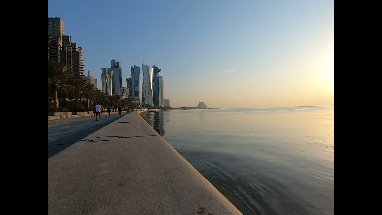 Serene Waterfront Promenade with a Stunning City Skyline