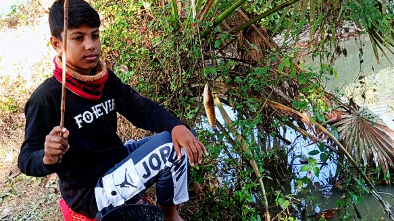 Boy waits quietly | hook floats beneath golden shimmer