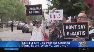 Demonstrators protest against Florida Gov. Ron DeSantis at Chelsea Piers