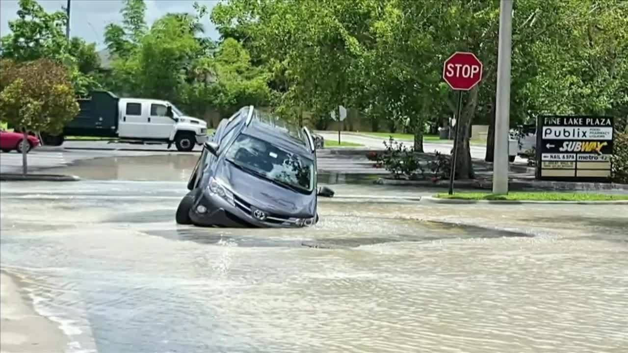 SUV partially swallowed by sinkhole in Cooper City - YouTube