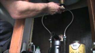 Hooking up a kitchen sink.Installing basket strainers and drain line on double kitchen sink.