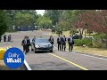 Kim Jong Un's body guards run alongside car carrying official