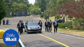 Kim Jong Un's body guards run alongside car carrying official Kim Jong Un's body guards run alongside car carrying official