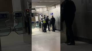 Man and Police Encounter at Train Station Gates