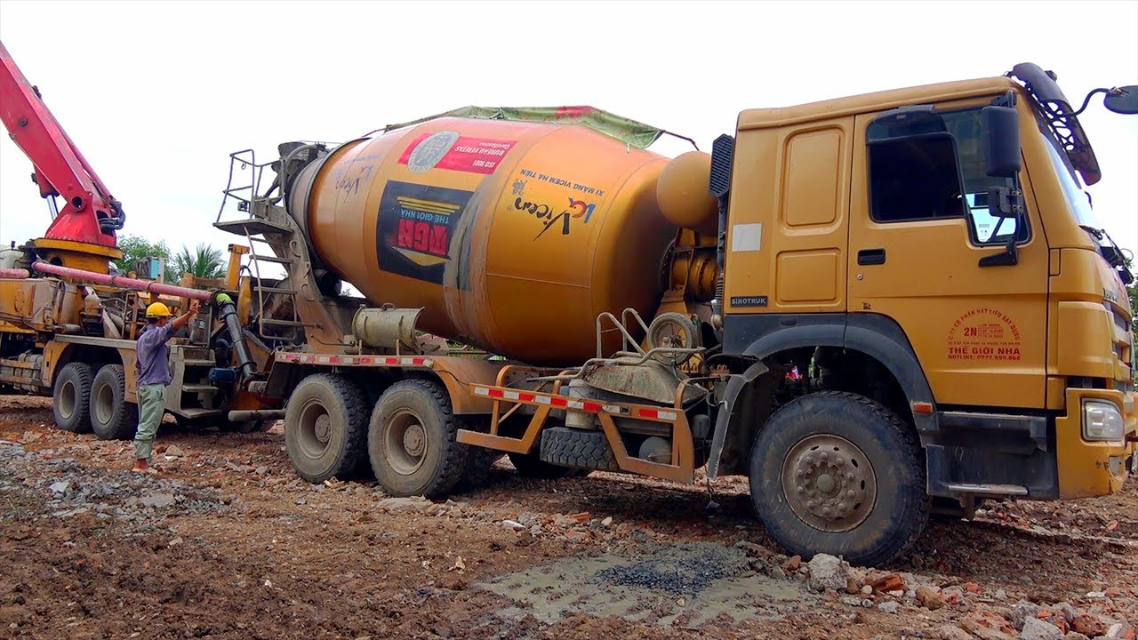 Concrete mixer truck works - excavator climbs on truck, crawls on ...