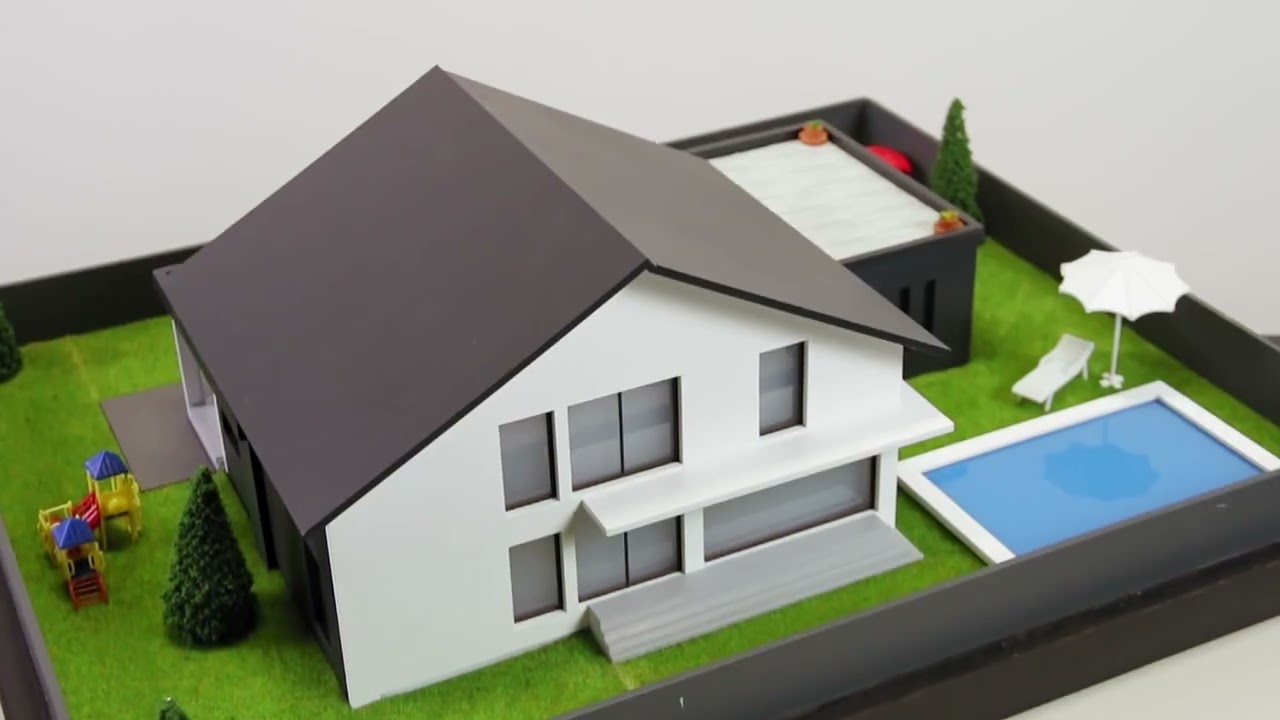 Maqueta de una casa con jardin y piscina 