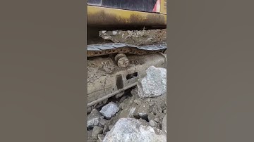 A moving excavator experienced track chain bolt detachment.