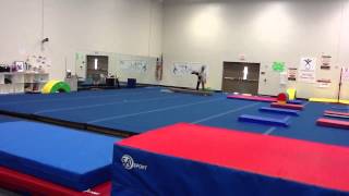 Nini working on back tuck on beam