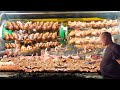 German Street Food. Rotating Machine Roasts Tons of Pork Knuckles, Ribs, Jumbo Sausages &amp; more