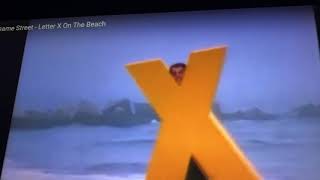 Sesame Street letter x on the beach