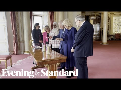 King and Queen consort light candles to remember horrors of the Holocaust