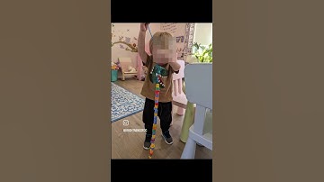 Working fine motor skills and hand-eye coordination by practicing with lacing beads.