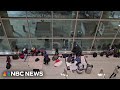 Migrants shelter inside Boston&#39;s Logan International Airport